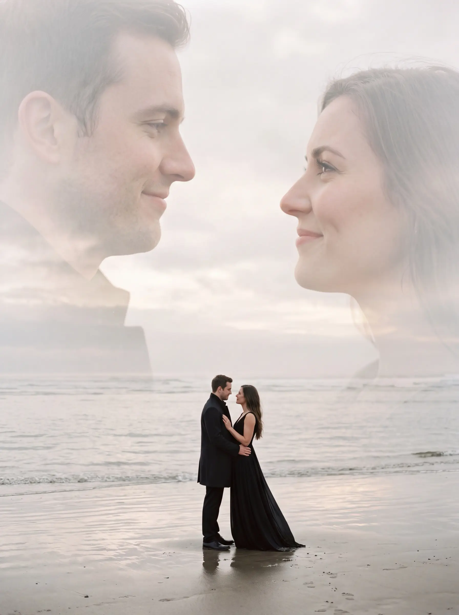 Couple embracing on a beach with their large faded profiles blended into the sky